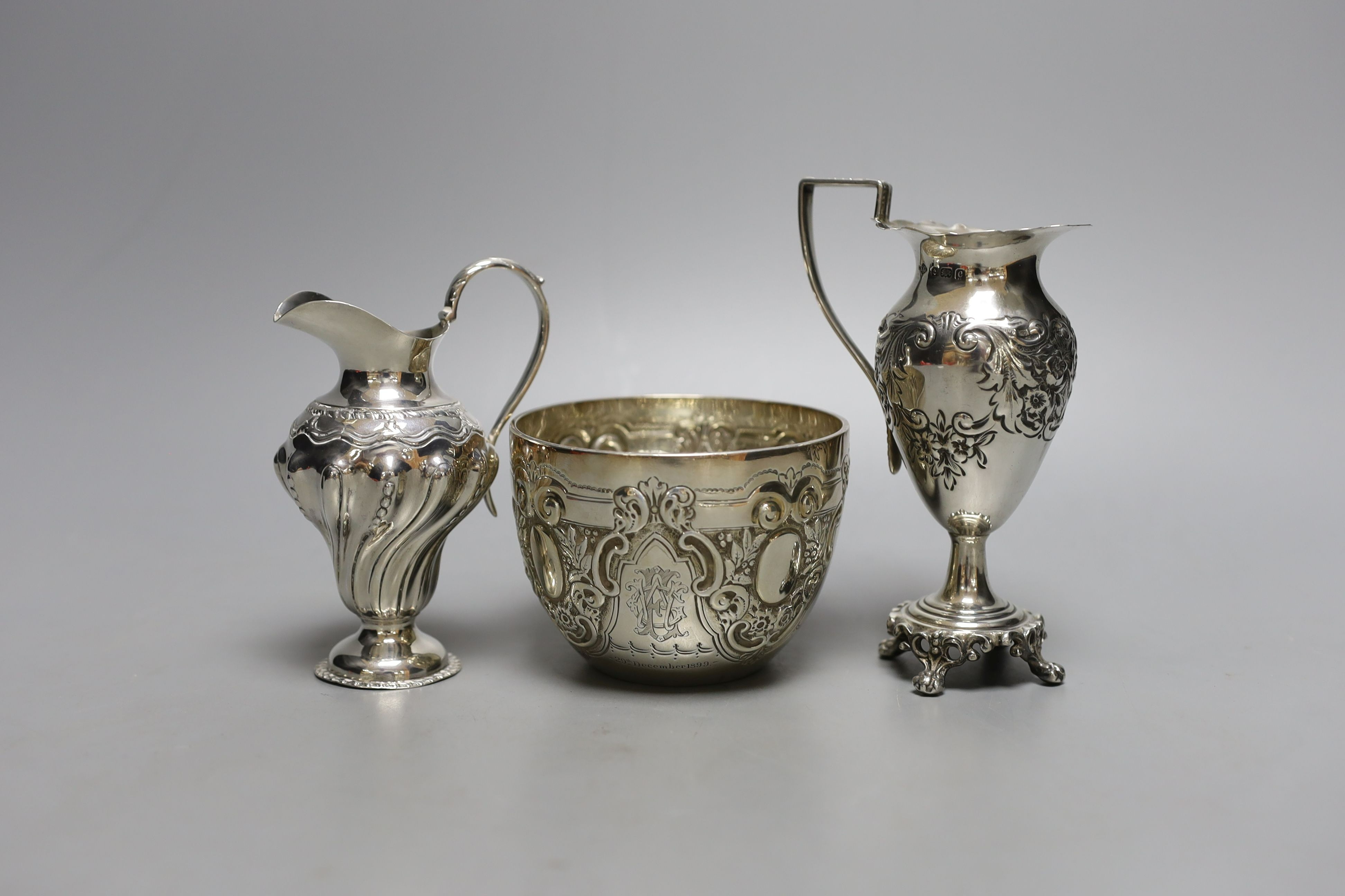 Two late 19th/early 20th century silver cream jugs, 13.5cm, and a late Victorian silver sugar bowl, 10oz.